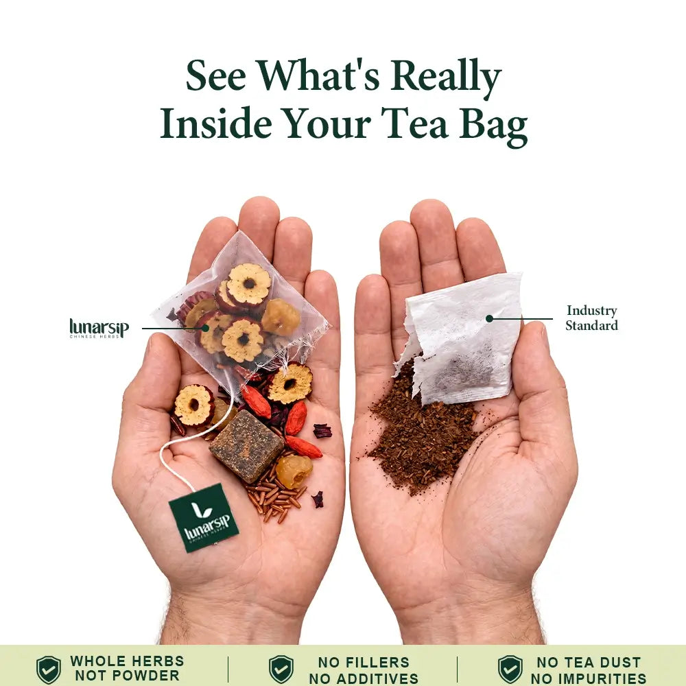 Hand holding a LunarSip Five Reds energy tea bag of whole red dates and goji next to a powdered tea bag
